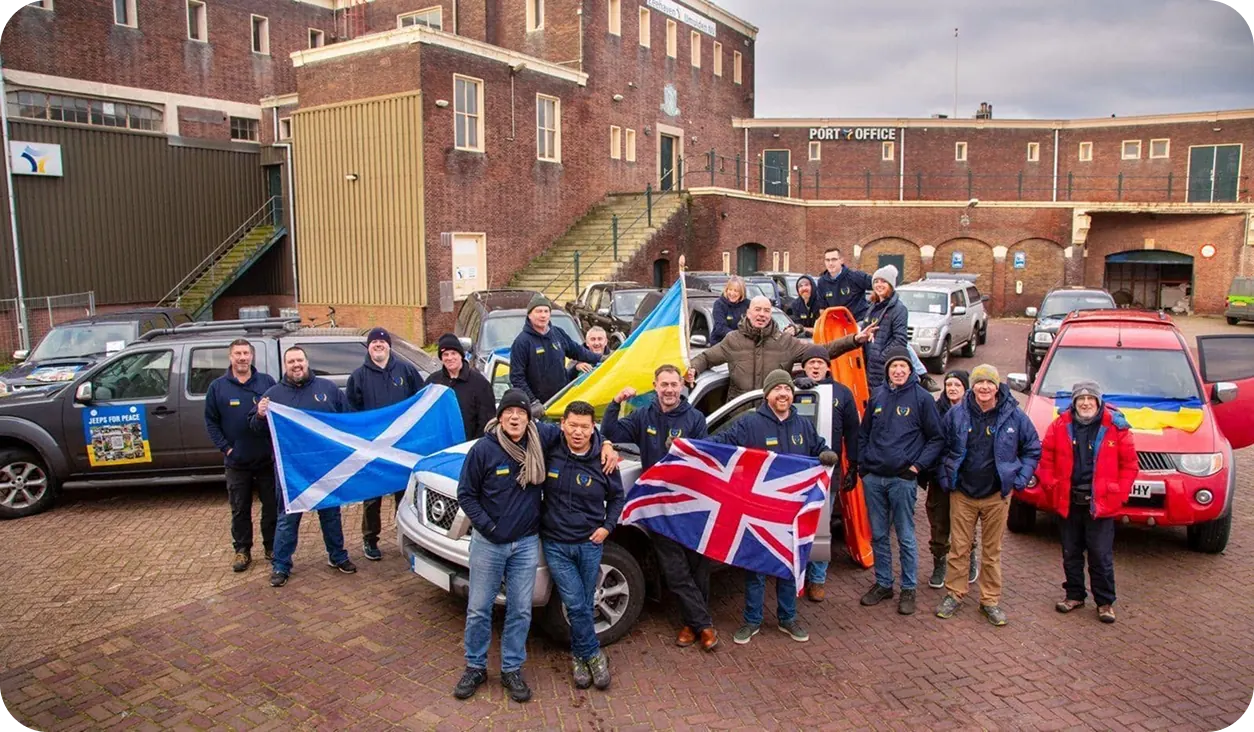 Jeeps for Peace volunteers with flags